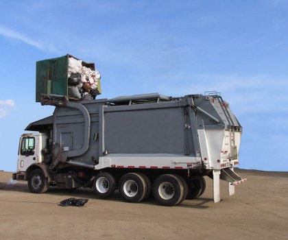 Workers loading a skip at a sustainable waste site in Sudbury